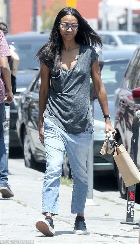 Zoe Saldana goes topless during her sun